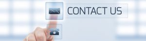 Contact us concept using woman hand touching a button. Futuristic contact us concept on light blue